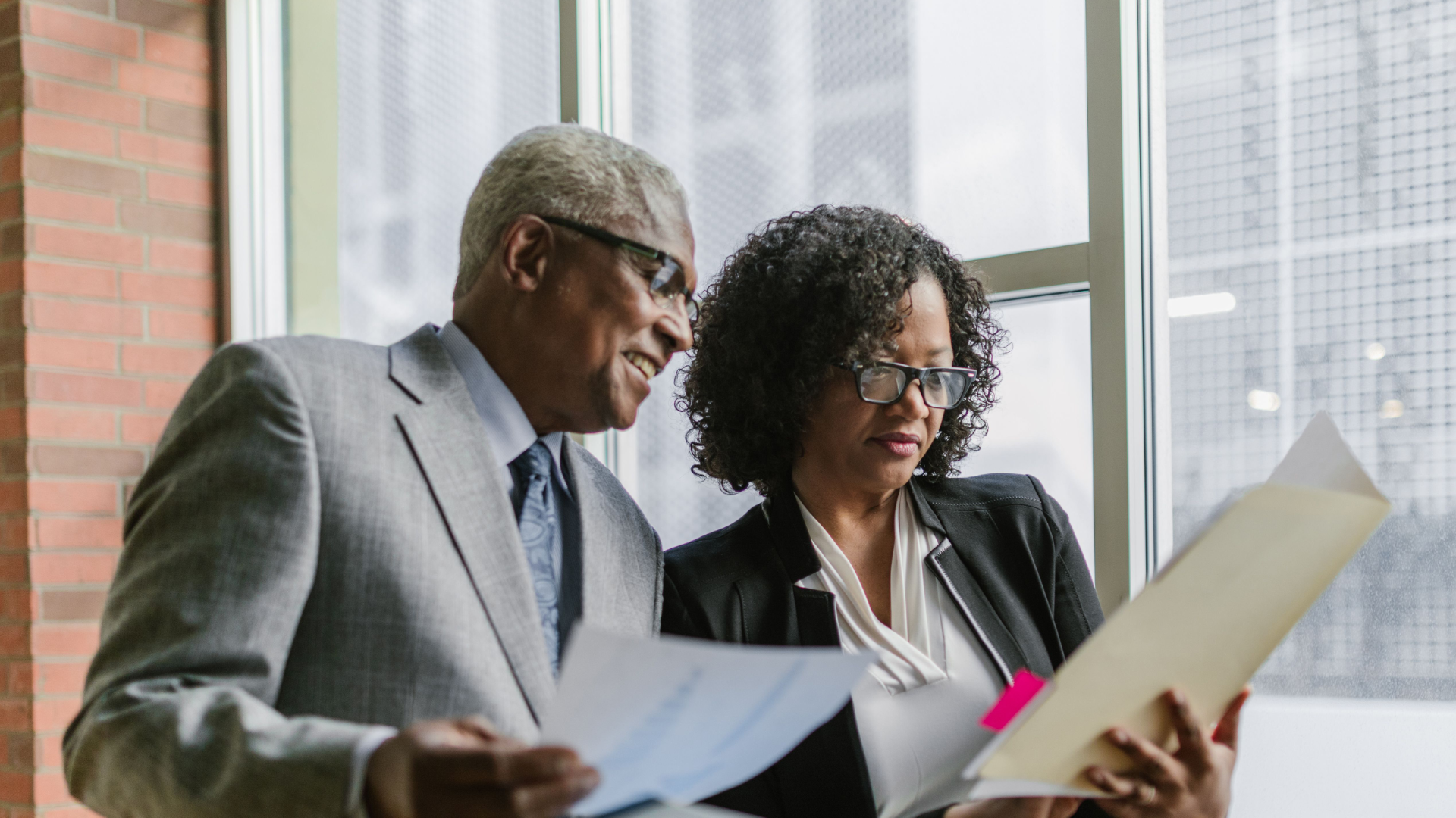 Two professionals reviewing Employment Equity workforce data and planning
