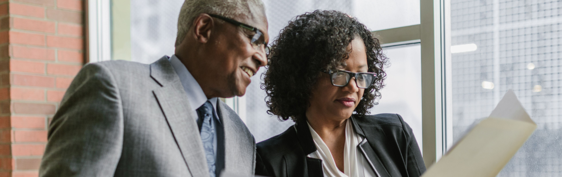 Two professionals reviewing Employment Equity workforce data and planning